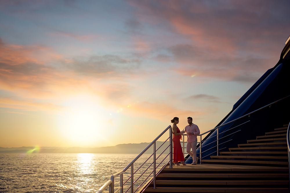 couple enjoying sunset on ritz carlton yacht